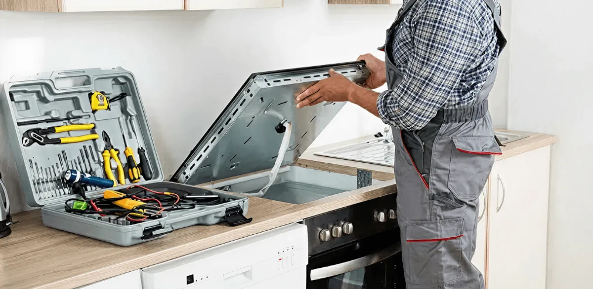 Handyman repairing a cooktop and checking wiring connections in Chandler, AZ