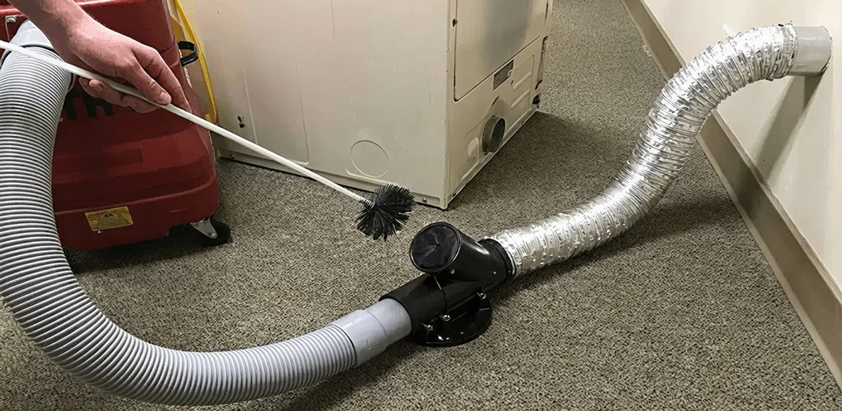 Dryer vent cleaning service removing lint from a dryer duct connection in Chandler, AZ