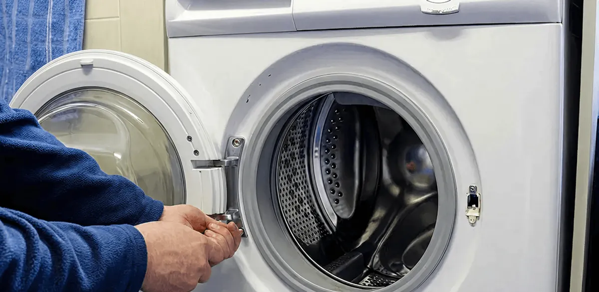 Washing machine repair handyman checking a front-load washer door and latch in Chandler, AZ