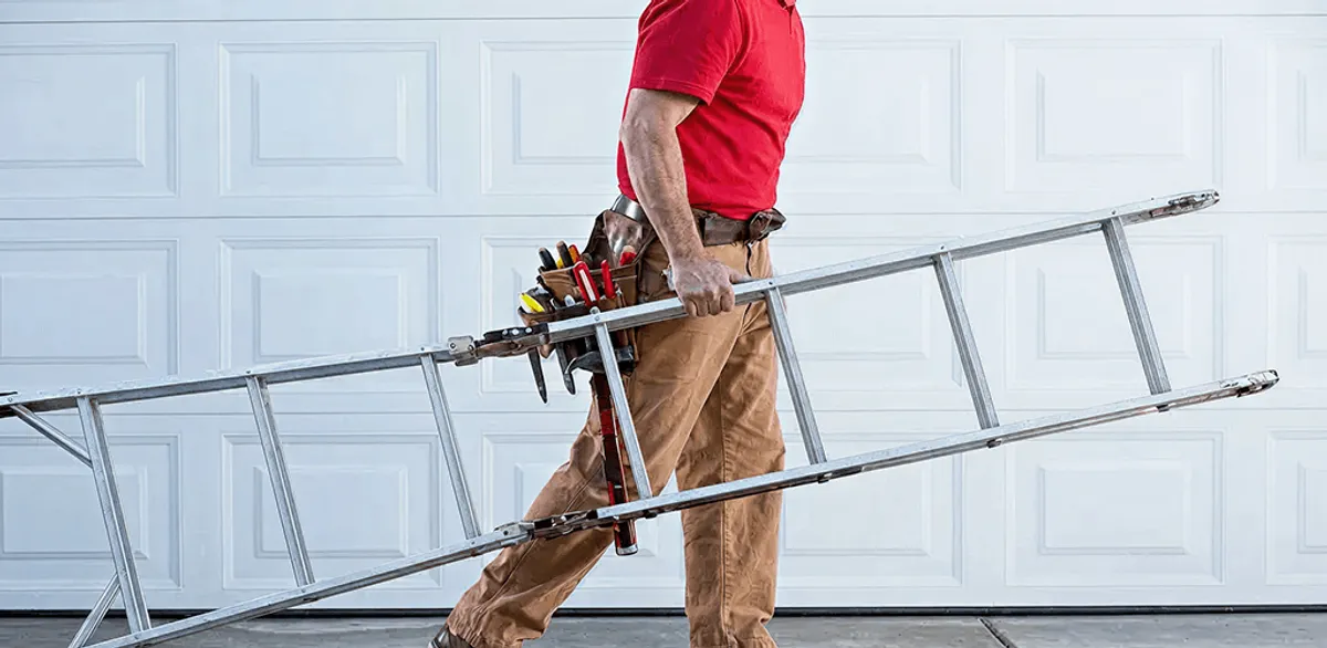 Garage door repair technician arriving with tools and ladder in Chandler, AZ