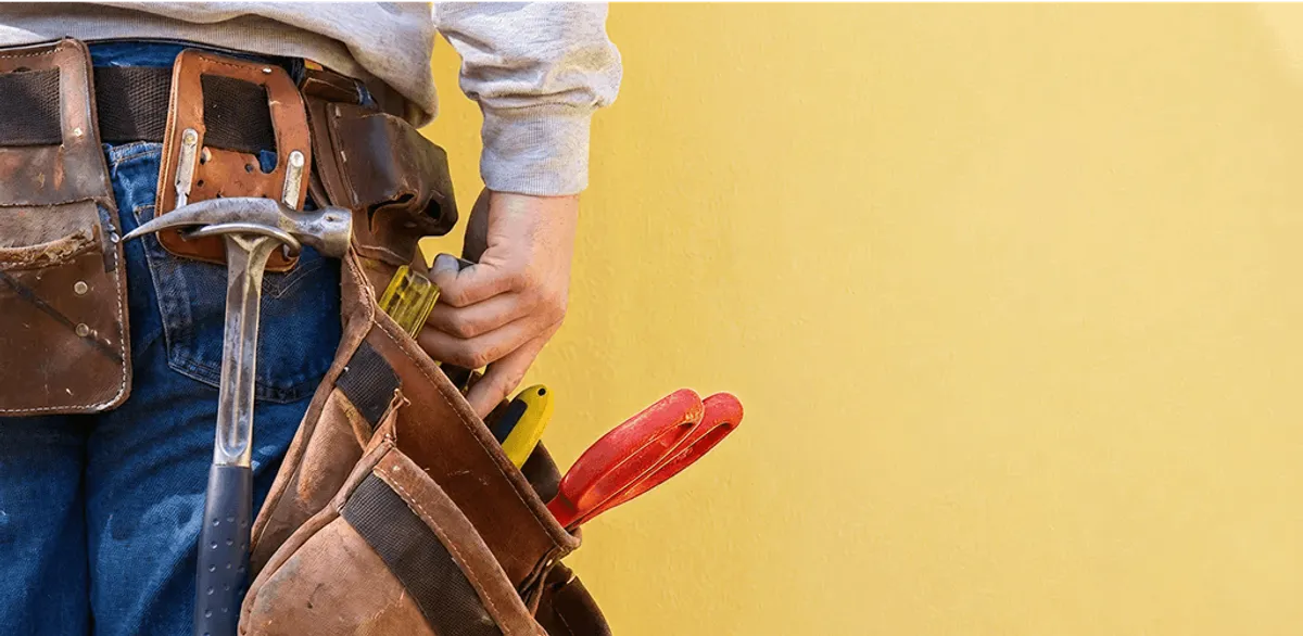 Handyman with tool belt ready for home repairs and maintenance in Chandler, AZ