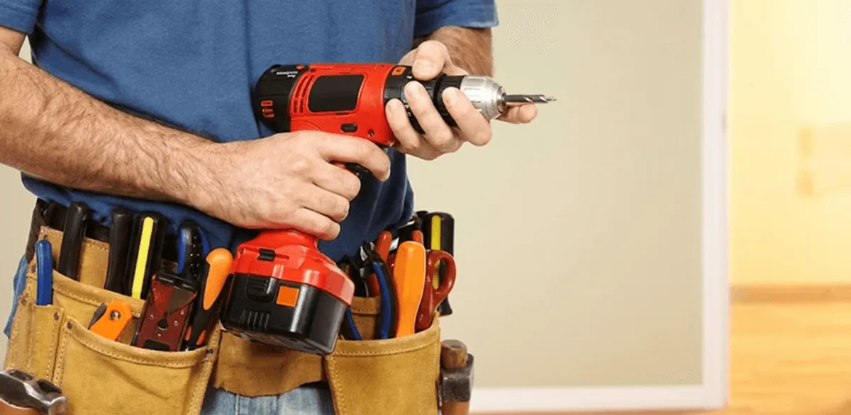 Handyman holding a power drill for home repairs and installations in Chandler, AZ