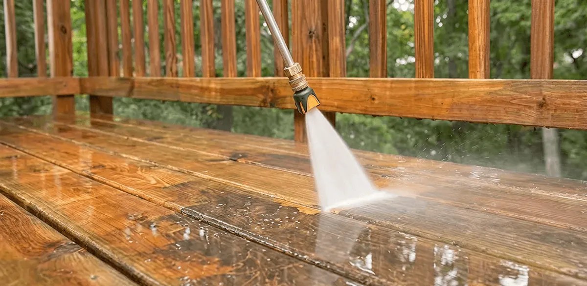 Pressure washing a wood deck to remove dirt and buildup in Chandler, AZ