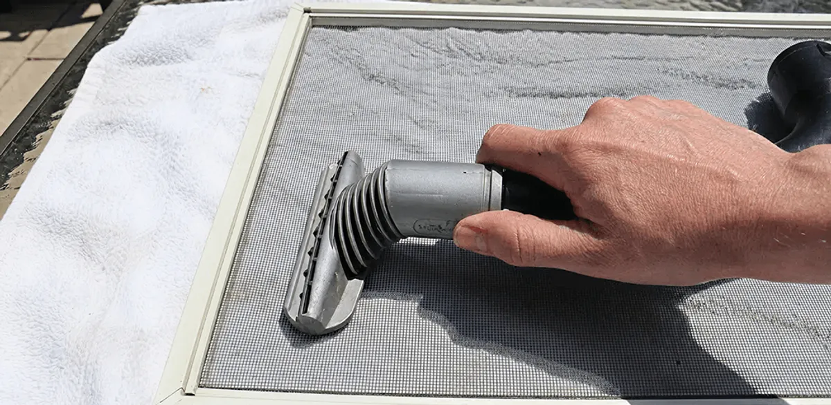 Window screen repair cleaning and fixing a damaged screen mesh in Chandler, AZ